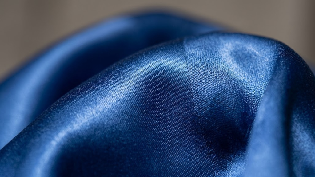 Close-up of silk fabric texture showing lustrous weave